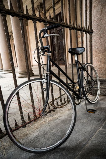 Bicycle parked in city street, Italy