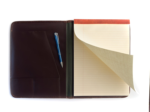 Note pad and binder with pen on white with page turning