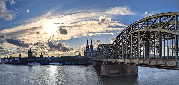 Sunset in Cologne, panoramic view of Cologne Cathedral, Hohenzollern Bridge and Rhine River