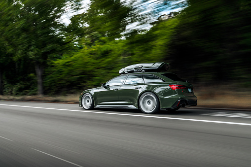 Seattle, WA, USA\nSeptember 27, 2023\nGreen Audi RS6 driving showing the drivers side