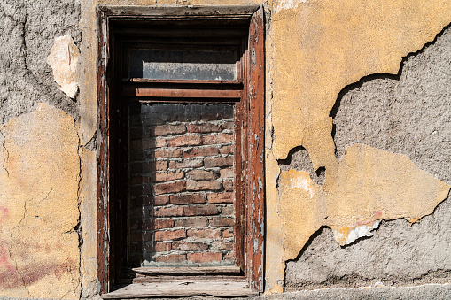 Old ruined abandoned mansion interior, vaulted window and door.