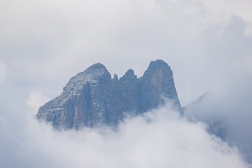 Scenic aerial view of Dolomites pinnacle mountains in clouds