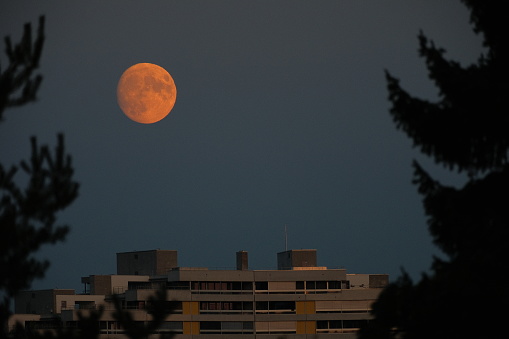 Moon rising over a residential building in Switzerland in September
