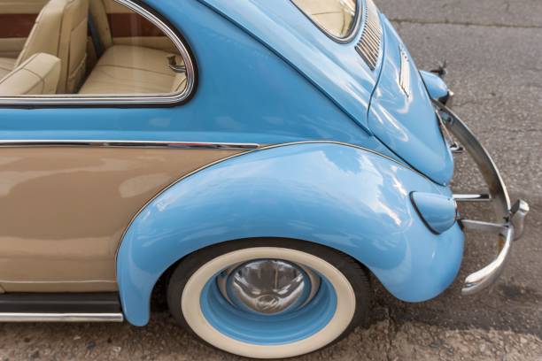 Beetle 1966 two colors, Santos, Brazil. April 20, 2018: Fender and back of old blue and beige car parked on the street. Selective focus.
