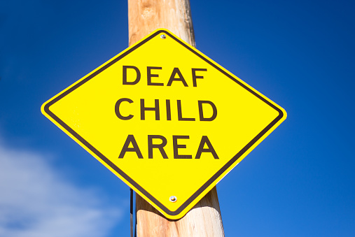 Yellow Sign Against Blue Sky: DEAF CHILD AREA