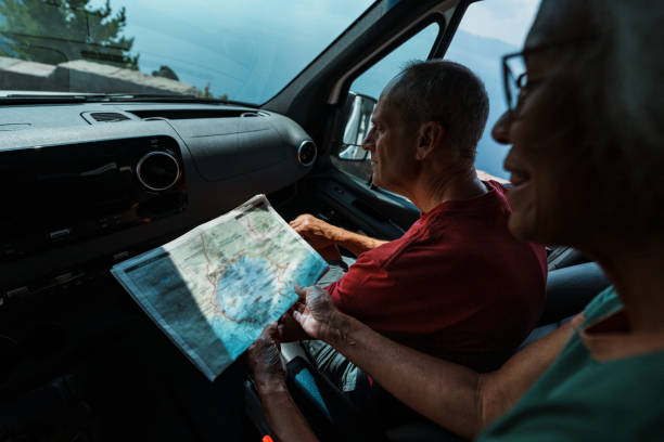 istock Vibrant senior couple looking on road trip looking at map 1704843546