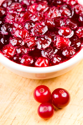 Cranberry sauce in bowl on wood table