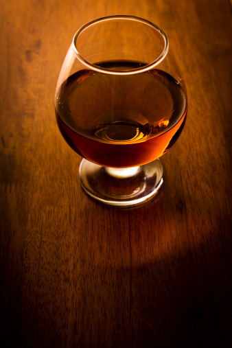 Glass of cognac on table