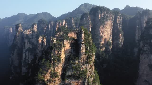 Zhangjiajie epic forest National Park at sunset. Aerial dolly out