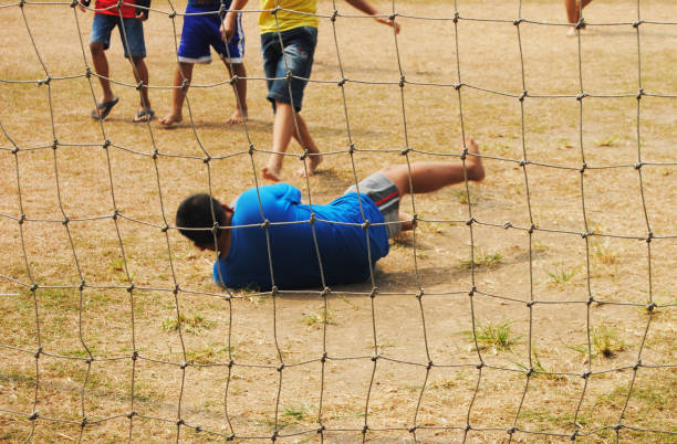 Kids playing football on grass