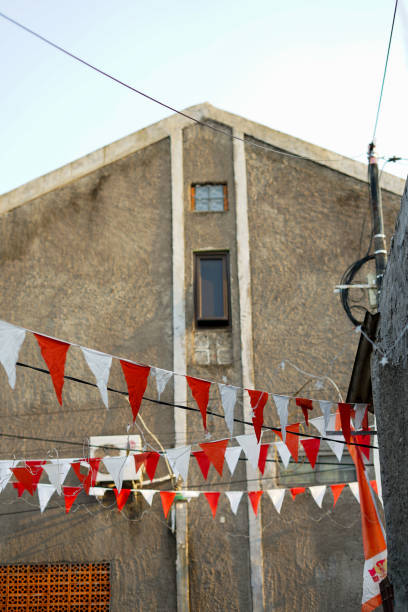 istock A small red and white triangular flag hanging on a residential street 1704978661