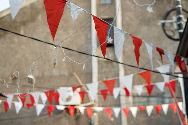 Street bunting decorations hanging above pedestrian  street and traditional windows in Galicia, Spain.