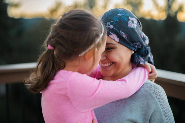 istock Woman in remission lovingly embracing daughter 1704982391