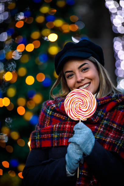 istock Pretty woman posing with a candy lollipop 1704992042