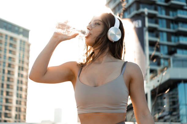 istock Girl enjoying music and refreshing while jogging 1704992615