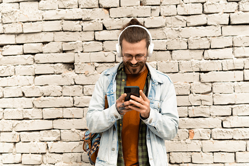 Portrait of a young man enjoying music outdoors