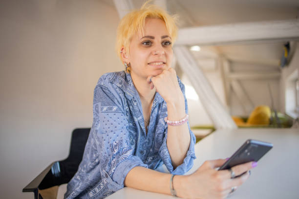 istock Happy young woman using phone 1704995056