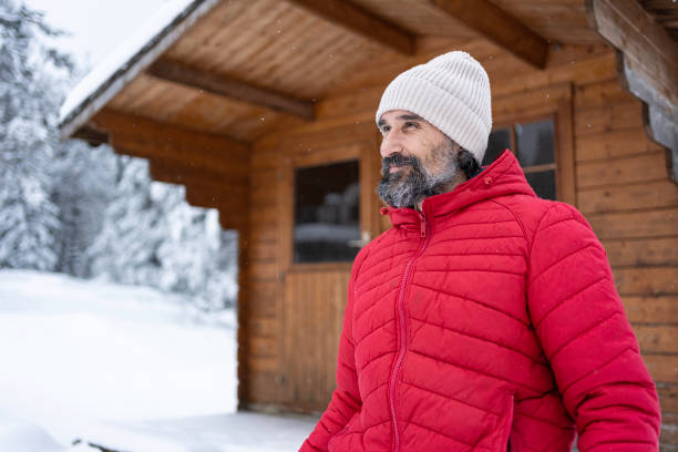 Cabin getaway. Man enjoys a log cabin retreat.