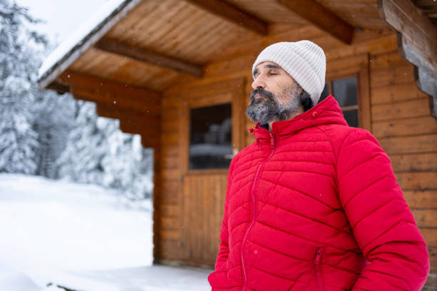 istock Cabin getaway. Man enjoys a log cabin retreat. 1705006038