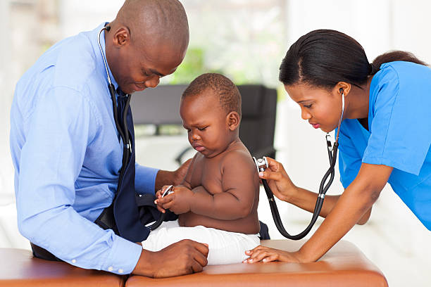 istock medical assistant examining a baby 170505028