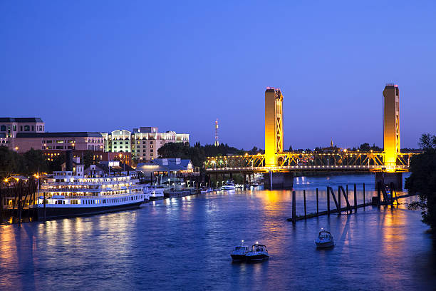 Sacramento River and Tower Bridge at dusk The landmark Tower Bridge in Sacramento, California at dusk, and the Sacramento River. sacramento ca stock pictures, royalty-free photos & images