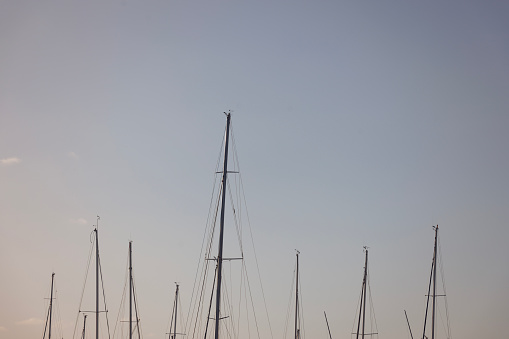 Abstract image of yacht masts at sunset