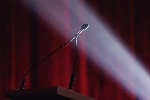 Microphone lit by dramatic stage lighting