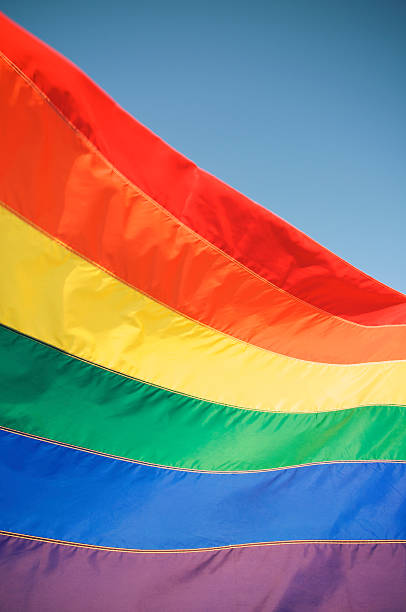 istock Rainbow Gay Pride Flag Waves in Sun against Blue Sky 170510435