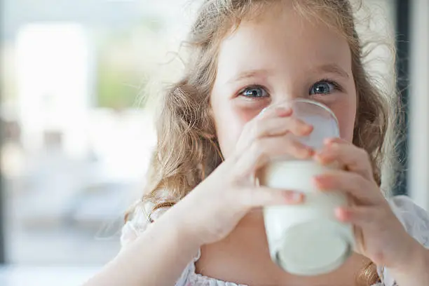 Photo of Girl drinking glass of milk