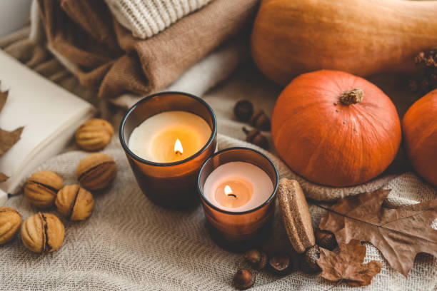 istock Two burning candles in the autumn interior 1705108793