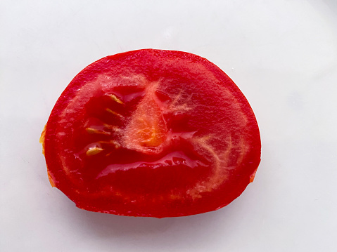 cut section of a tomato with an angry face expression
