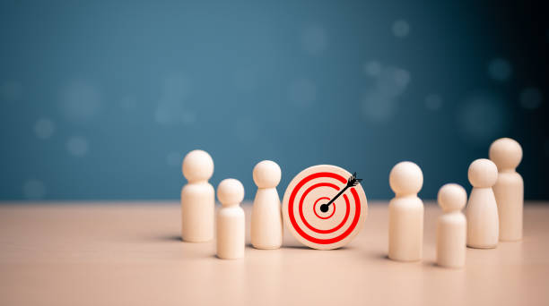 istock Target, Achieving goal concept. Wooden figures standing around dartboard and arrow for creative start-up and set up business objective target, online marketing solution, company business investment. 1705119320