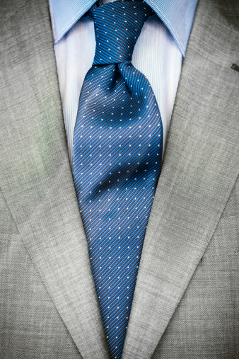 Elegant businessman close up on necktie