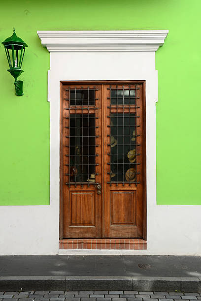 A door of a shop in a vibrantly painted building along a street in Old San Juan.