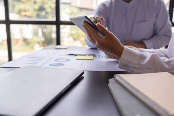 istock Team businesspeople or an accountant team are analyzing data charts, graphs, and a dashboard on a laptop screen in order to prepare a statistical report and discuss financial data in an office. 1705145142