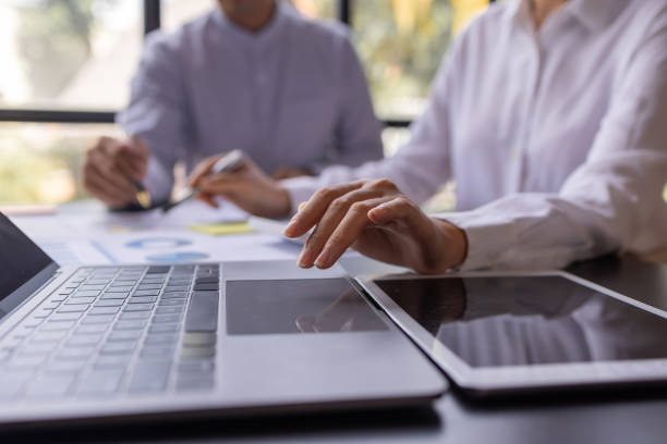 istock Team businesspeople or an accountant team are analyzing data charts, graphs, and a dashboard on a laptop screen in order to prepare a statistical report and discuss financial data in an office. 1705145145