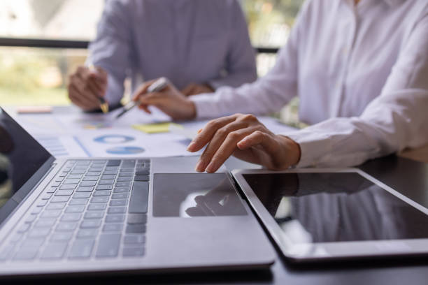 istock Team businesspeople or an accountant team are analyzing data charts, graphs, and a dashboard on a laptop screen in order to prepare a statistical report and discuss financial data in an office. 1705145147
