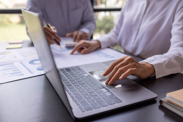 istock Team businesspeople or an accountant team are analyzing data charts, graphs, and a dashboard on a laptop screen in order to prepare a statistical report and discuss financial data in an office. 1705145163