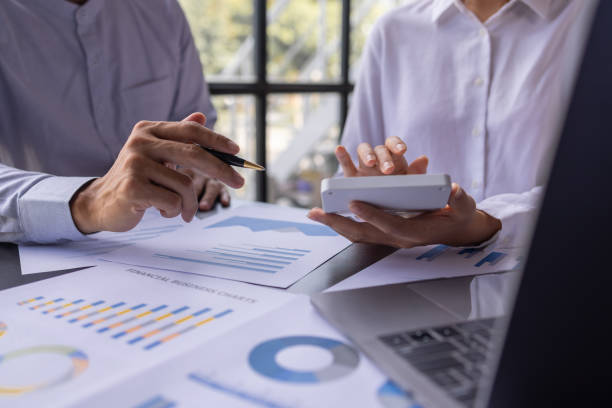 istock Team businesspeople or an accountant team are analyzing data charts, graphs, and a dashboard on a laptop screen in order to prepare a statistical report and discuss financial data in an office. 1705145169