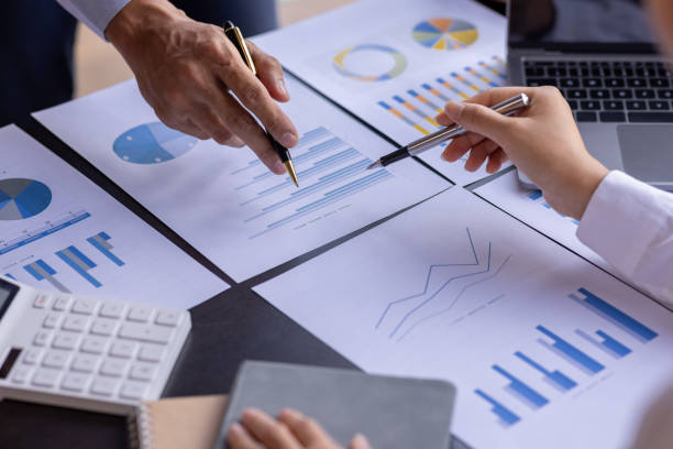 istock Team businesspeople or an accountant team are analyzing data charts, graphs, and a dashboard on a laptop screen in order to prepare a statistical report and discuss financial data in an office. 1705145678