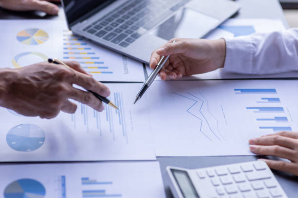 istock Team businesspeople or an accountant team are analyzing data charts, graphs, and a dashboard on a laptop screen in order to prepare a statistical report and discuss financial data in an office. 1705145691