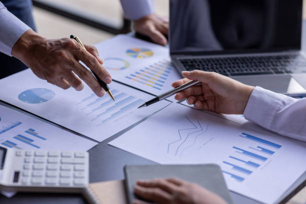 istock Team businesspeople or an accountant team are analyzing data charts, graphs, and a dashboard on a laptop screen in order to prepare a statistical report and discuss financial data in an office. 1705145695