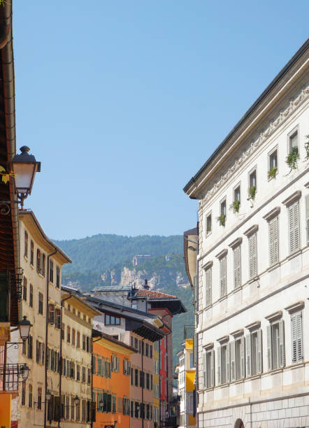 Old houses on a narrow street in Trento, Italy
