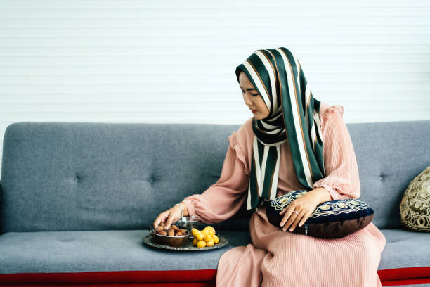 istock Young asian muslim woman eating dates fruit 1705159342