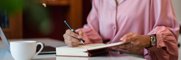 istock Female entrepreneur write data in notebook while working about strategy new startup in home office 1705182119