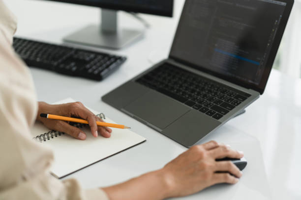 Developer programmer use mouse and checking code on laptop while programming to developing website Developer programmer use mouse and checking code on laptop while programming to developing website. java mouse in stock pictures, royalty-free photos & images