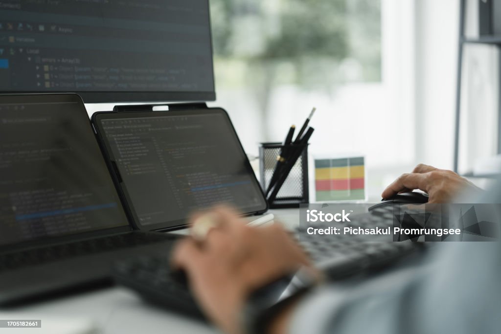 Developer Programmer Checking Code On Multiple Monitor While ...