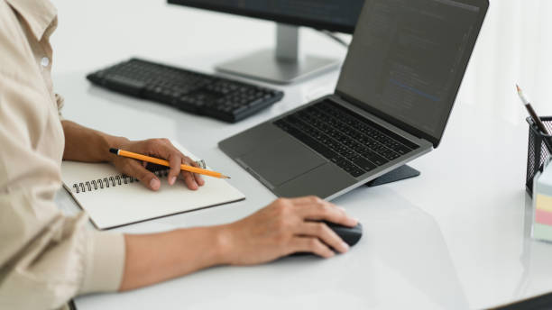 Developer programmer use mouse and checking code on laptop while programming to developing website Developer programmer use mouse and checking code on laptop while programming to developing website. java mouse in stock pictures, royalty-free photos & images
