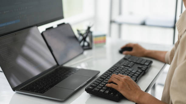 Developer programmer checking code on multiple monitor while programming to developing web and apps Developer programmer checking code on multiple monitor while programming to developing web and apps. java mouse in stock pictures, royalty-free photos & images