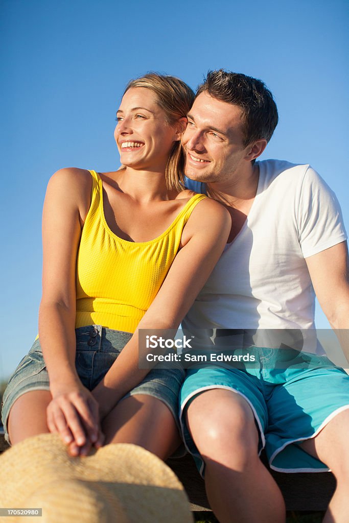 Seduta di coppia insieme sul molo - Foto stock royalty-free di 12-13 anni